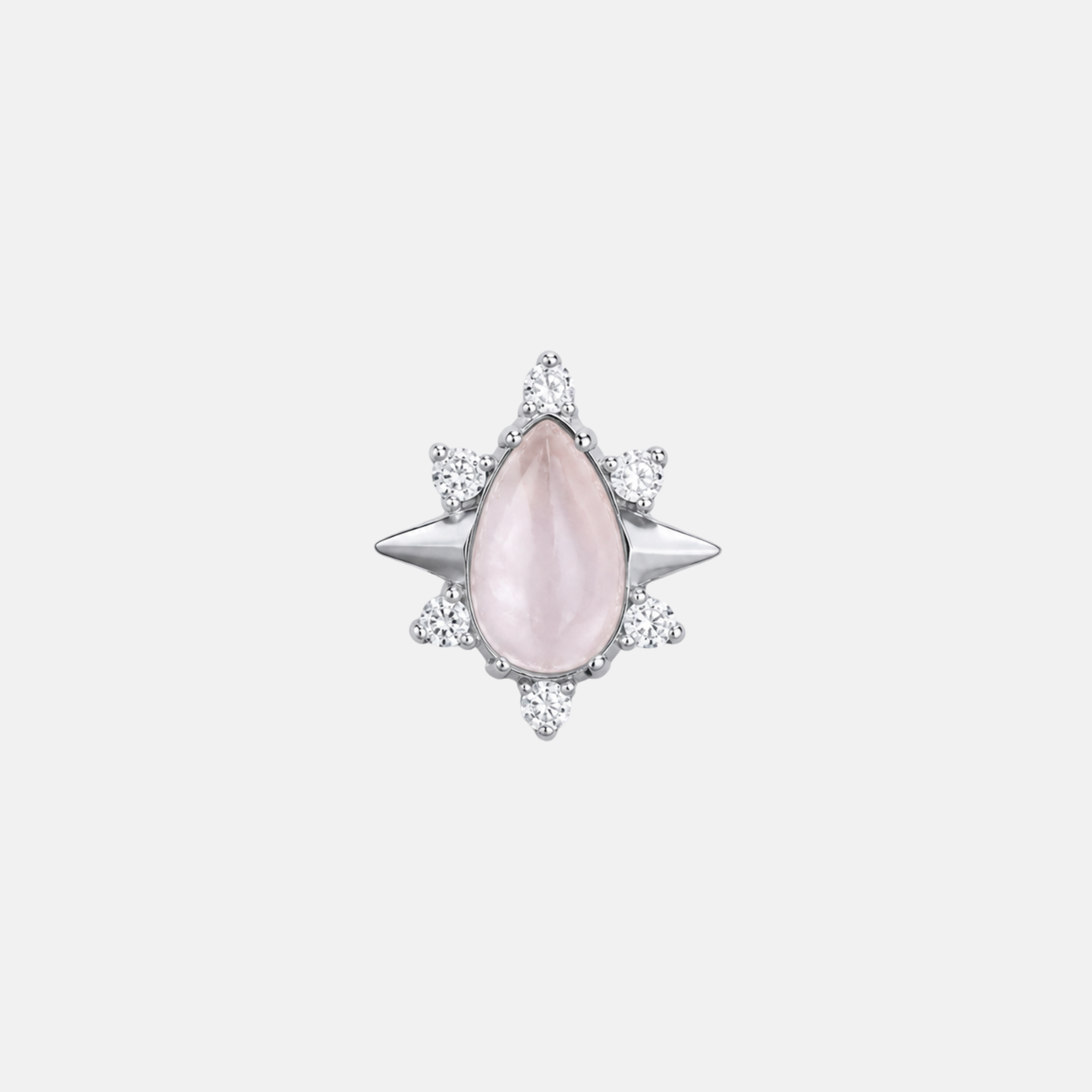 Pink teardrop-shaped gemstone with silver starburst setting on a light gray background